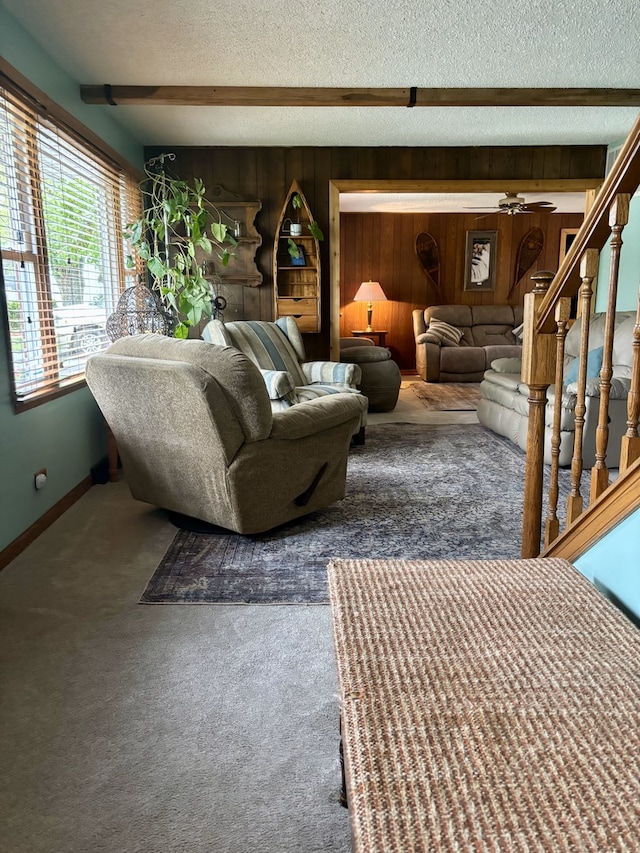 5116 154th St, Oak Forest, IL 60452 - carpeted living room featuring wooden walls, a textured ceiling, baseboards, and ceiling fan