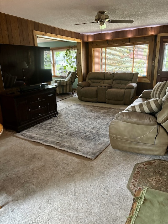 5116 154th St, Oak Forest, IL 60452 - living area featuring wooden walls, a textured ceiling, carpet, and a ceiling fan