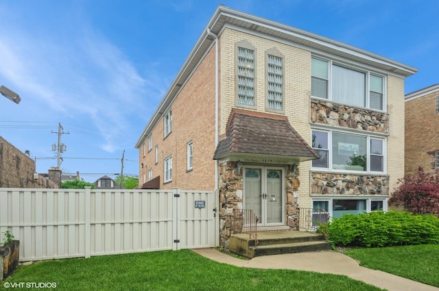 5639 W Montrose Ave, Chicago, IL 60634 - view of front of house featuring stone siding and a gate