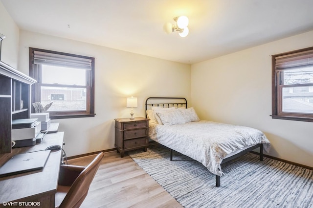 5639 W Montrose Ave, Chicago, IL 60634 - bedroom featuring multiple windows, light wood-type flooring, baseboards, and a desk