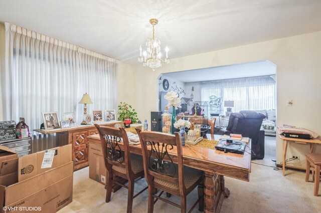 5639 W Montrose Ave, Chicago, IL 60634 - dining room featuring light carpet and a chandelier