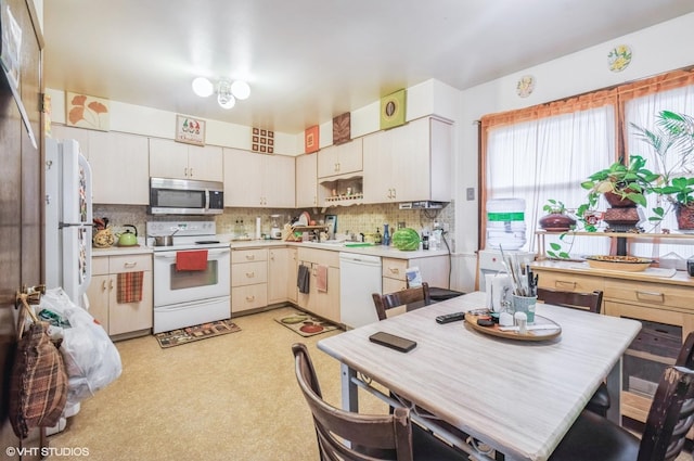 5639 W Montrose Ave, Chicago, IL 60634 - kitchen with white appliances, light countertops, decorative backsplash, and a sink