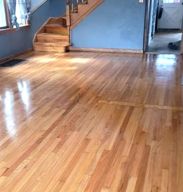 6432 41st St, Stickney, IL 60402 - unfurnished living room featuring hardwood / wood-style floors, stairs, and baseboards