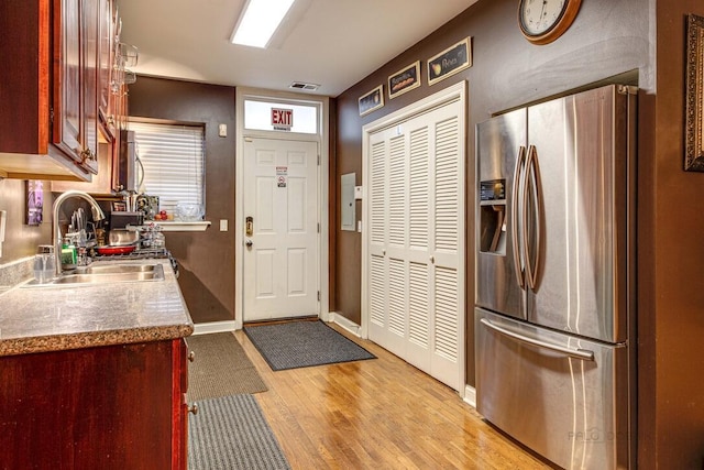 5942 S King Dr Unit 2N, Chicago, IL 60637 - kitchen with stainless steel fridge with ice dispenser, a sink, light wood-style flooring, baseboards, and reddish brown cabinets