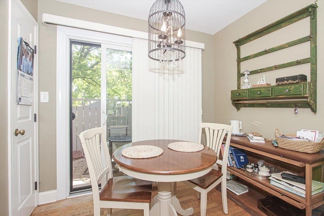 196 Shoreline Rd, Lake Barrington, IL 60010 - dining room with a chandelier, wood finished floors, and baseboards