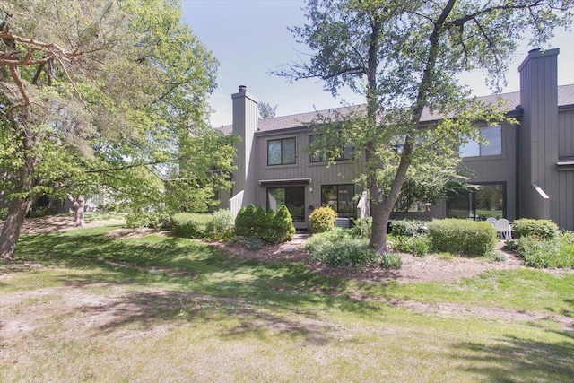 196 Shoreline Rd, Lake Barrington, IL 60010 - rear view of property with a chimney and a yard