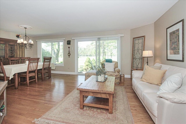 196 Shoreline Rd, Lake Barrington, IL 60010 - living room with a chandelier, light wood-style flooring, and baseboards