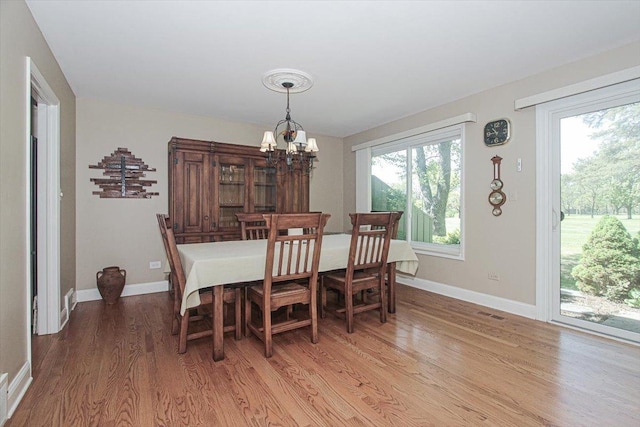 196 Shoreline Rd, Lake Barrington, IL 60010 - dining space featuring a chandelier, light wood-style floors, and baseboards