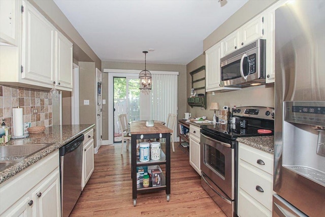 196 Shoreline Rd, Lake Barrington, IL 60010 - kitchen featuring appliances with stainless steel finishes, a chandelier, light wood-style flooring, and white cabinets