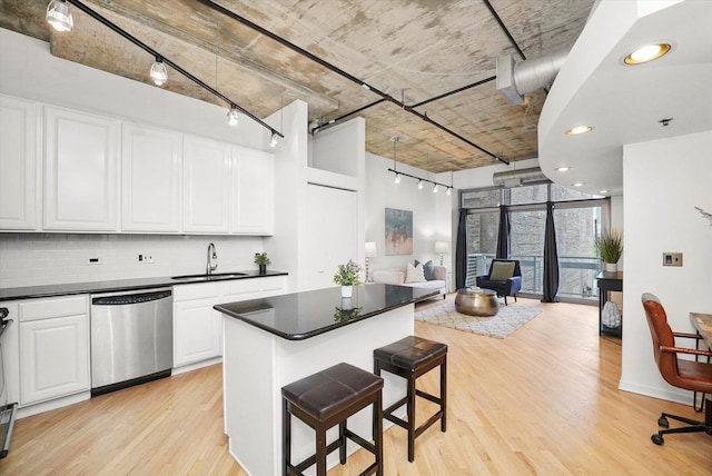 933 W Van Buren St Unit 320, Chicago, IL 60607 - kitchen with dishwasher, a sink, open floor plan, light wood-type flooring, and backsplash