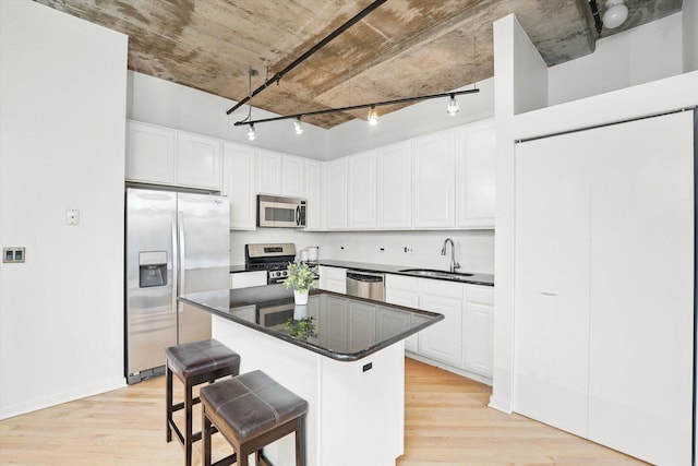 933 W Van Buren St Unit 320, Chicago, IL 60607 - kitchen with stainless steel appliances, a sink, light wood finished floors, and white cabinetry