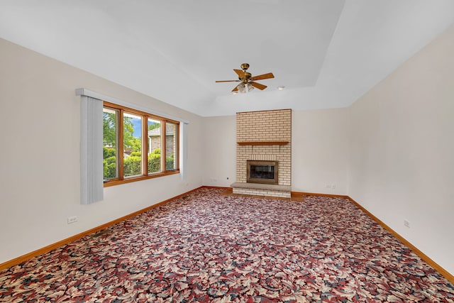 1212 Ashford Ln, Joliet, IL 60431 - unfurnished living room with ceiling fan, carpet flooring, baseboards, a fireplace, and vaulted ceiling