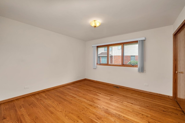 1212 Ashford Ln, Joliet, IL 60431 - empty room with light wood finished floors and baseboards