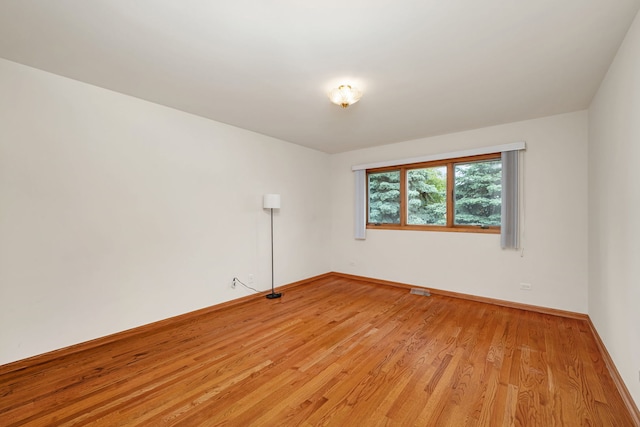 1212 Ashford Ln, Joliet, IL 60431 - spare room featuring light wood-style floors and baseboards