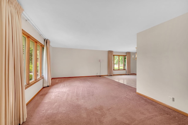 1212 Ashford Ln, Joliet, IL 60431 - empty room with light colored carpet, a chandelier, and baseboards