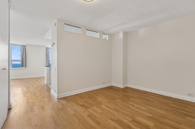 474 N Lake Shore Dr Unit 5306, Chicago, IL 60611 - spare room with light wood-style floors, healthy amount of natural light, and a textured ceiling
