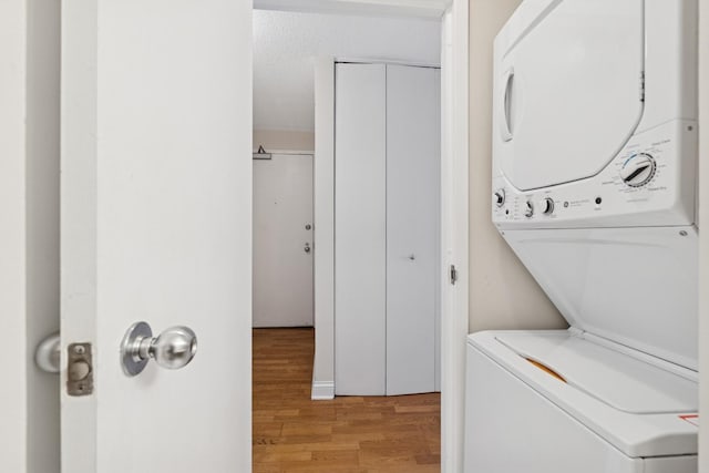 474 N Lake Shore Dr Unit 5306, Chicago, IL 60611 - washroom with stacked washer and clothes dryer and light wood-style flooring