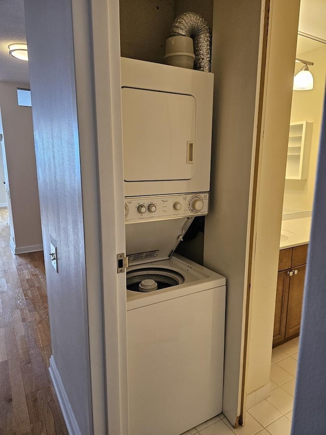 474 N Lake Shore Dr Unit 5306, Chicago, IL 60611 - washroom with stacked washer / drying machine, light wood-type flooring, and baseboards