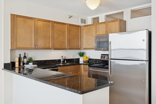 474 N Lake Shore Dr Unit 5306, Chicago, IL 60611 - kitchen with appliances with stainless steel finishes, a peninsula, and dark stone countertops