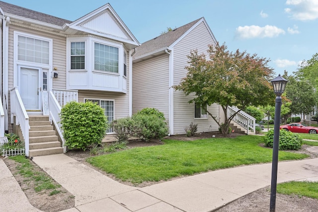 415 Hidden Creek Ln Unit 415, North Aurora, IL 60542 - view of property exterior featuring a lawn and stairs