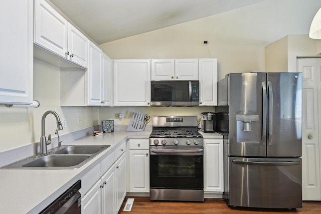 415 Hidden Creek Ln Unit 415, North Aurora, IL 60542 - kitchen featuring stainless steel appliances, a sink, vaulted ceiling, white cabinets, and light countertops