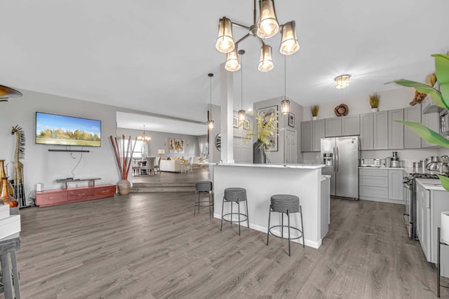 22334 Ojai Dr, Richton Park, IL 60471 - kitchen featuring appliances with stainless steel finishes, gray cabinetry, a chandelier, a breakfast bar, and light wood-style floors