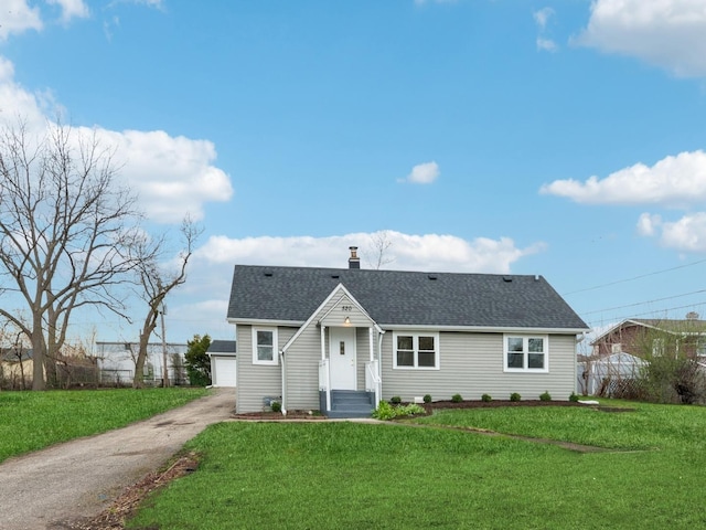 520 W Pheasant Ct, Round Lake Beach, IL 60073 - view of front facade featuring a shingled roof, an outdoor structure, and a chimney