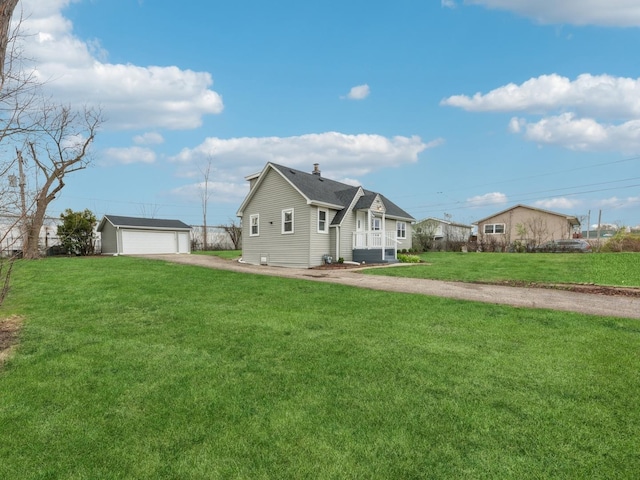 520 W Pheasant Ct, Round Lake Beach, IL 60073 - back of house featuring an outbuilding, a detached garage, a lawn, and a chimney