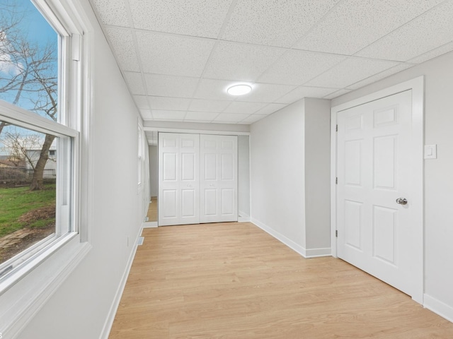 520 W Pheasant Ct, Round Lake Beach, IL 60073 - hallway featuring light wood finished floors, a drop ceiling, baseboards, and plenty of natural light