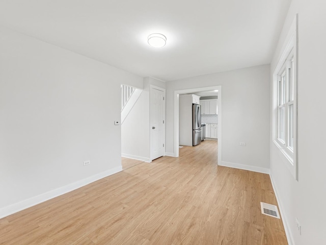 520 W Pheasant Ct, Round Lake Beach, IL 60073 - unfurnished room featuring light wood-style flooring and baseboards
