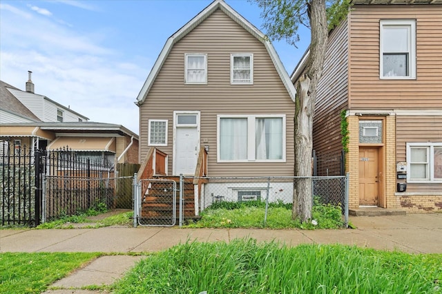 3823 W Wabansia Ave, Chicago, IL 60647 - colonial inspired home featuring a gate, a gambrel roof, and a fenced front yard