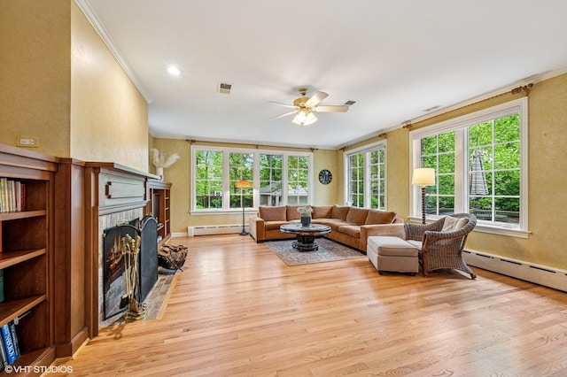 1117 Keystone Ave, River Forest, IL 60305 - living area with a baseboard heating unit, ornamental molding, a brick fireplace, ceiling fan, and light wood-style floors