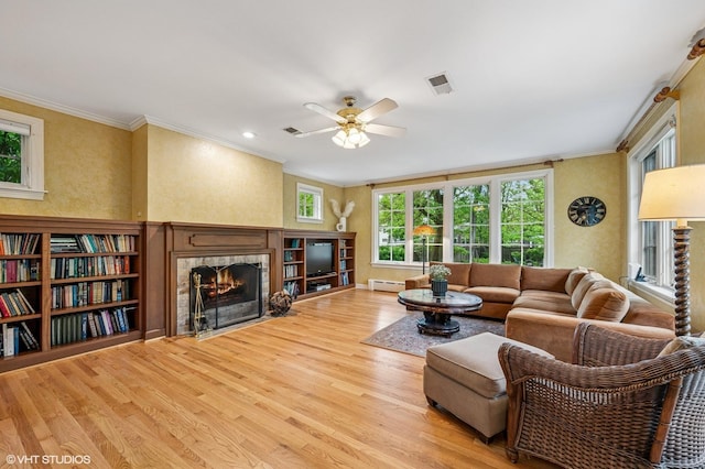 1117 Keystone Ave, River Forest, IL 60305 - living area featuring baseboard heating, a fireplace with flush hearth, ornamental molding, wood finished floors, and plenty of natural light