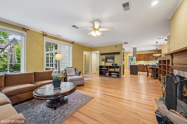 1117 Keystone Ave, River Forest, IL 60305 - living area featuring light wood finished floors, a fireplace with flush hearth, a ceiling fan, crown molding, and recessed lighting