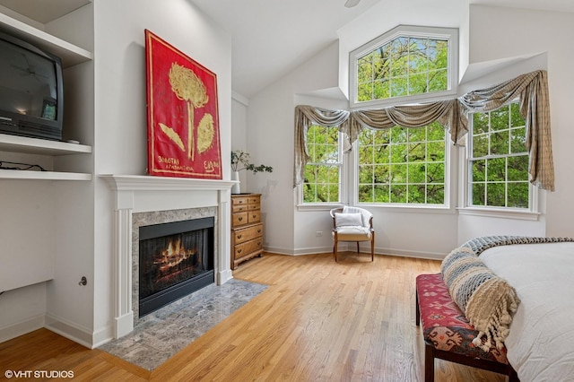 1117 Keystone Ave, River Forest, IL 60305 - bedroom featuring wood finished floors, a high end fireplace, vaulted ceiling, and baseboards
