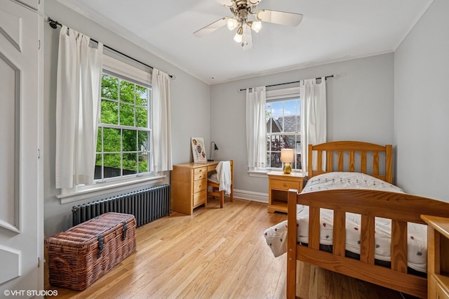1117 Keystone Ave, River Forest, IL 60305 - bedroom featuring radiator heating unit, multiple windows, light wood-style flooring, baseboards, and crown molding
