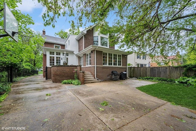 1117 Keystone Ave, River Forest, IL 60305 - back of house with brick siding, a gate, and a chimney