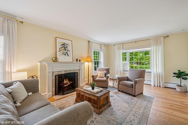 1117 Keystone Ave, River Forest, IL 60305 - living area featuring wood finished floors, a warm lit fireplace, a baseboard radiator, and a baseboard heating unit