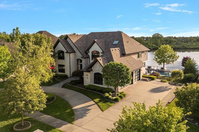 21186 Sage Brush Ln, Mokena, IL 60448 - french provincial home with concrete driveway, stone siding, and roof with shingles