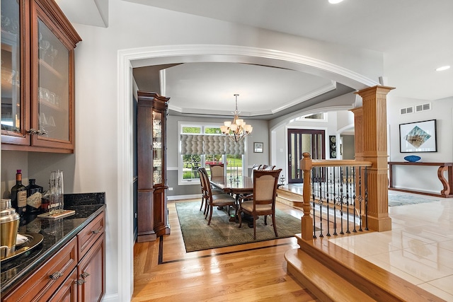 21186 Sage Brush Ln, Mokena, IL 60448 - dining space with arched walkways, baseboards, a bar, decorative columns, and recessed lighting