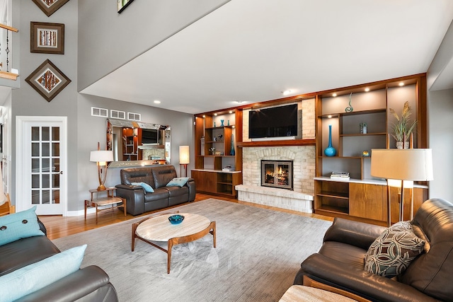21186 Sage Brush Ln, Mokena, IL 60448 - living room featuring a fireplace, wood finished floors, baseboards, built in shelves, and recessed lighting