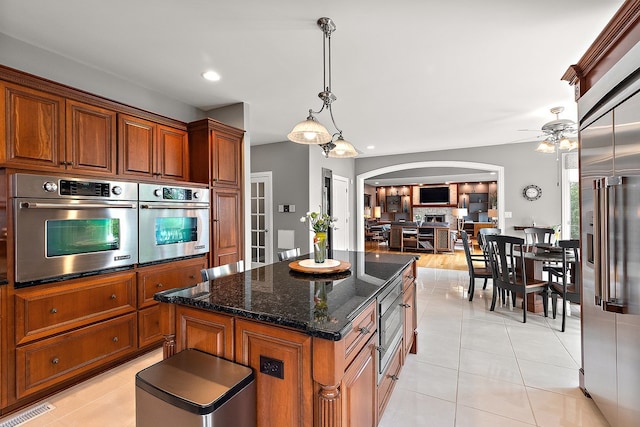 21186 Sage Brush Ln, Mokena, IL 60448 - kitchen featuring appliances with stainless steel finishes, arched walkways, a ceiling fan, a kitchen island, and open floor plan