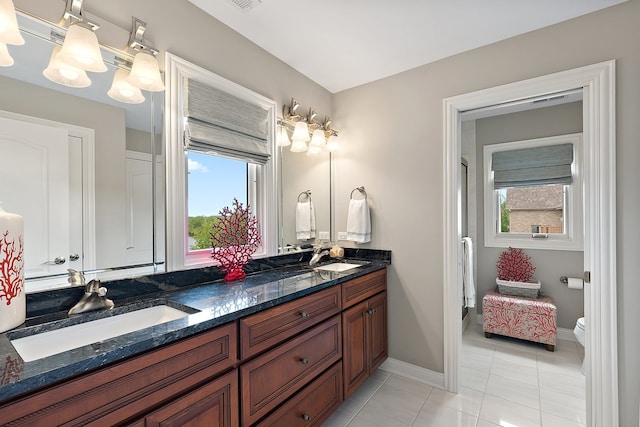 21186 Sage Brush Ln, Mokena, IL 60448 - bathroom with healthy amount of natural light, double vanity, tile patterned flooring, and toilet