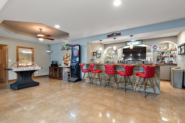 21186 Sage Brush Ln, Mokena, IL 60448 - kitchen featuring a ceiling fan, a breakfast bar area, a tray ceiling, a peninsula, and recessed lighting