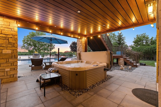 21186 Sage Brush Ln, Mokena, IL 60448 - patio terrace at dusk with a hot tub, a patio area, and stairs