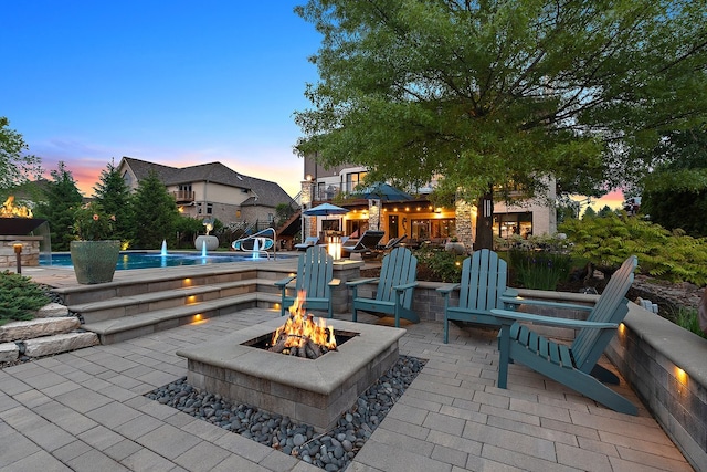 21186 Sage Brush Ln, Mokena, IL 60448 - patio terrace at dusk featuring a fire pit, a patio, and an outdoor pool