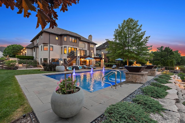 21186 Sage Brush Ln, Mokena, IL 60448 - pool at dusk with an outdoor fire pit, stairs, and a patio area