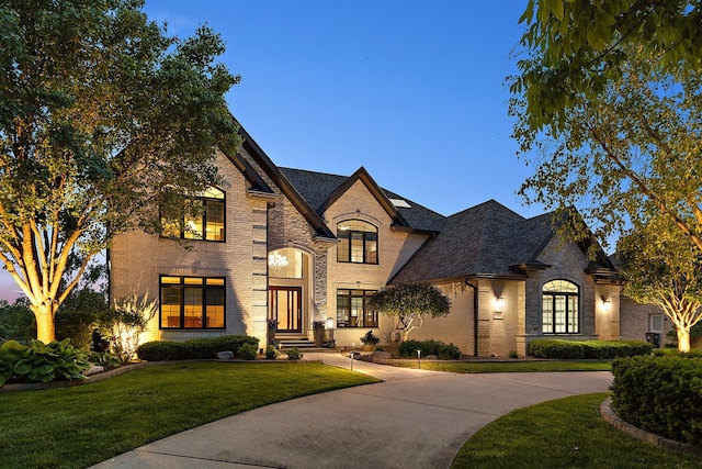 21186 Sage Brush Ln, Mokena, IL 60448 - french country inspired facade featuring a front yard, brick siding, and curved driveway