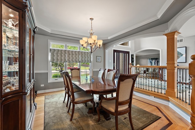 21186 Sage Brush Ln, Mokena, IL 60448 - dining space featuring arched walkways, a chandelier, ornamental molding, decorative columns, and a tray ceiling