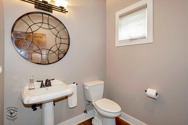 1233 Prairie Ln, Lemont, IL 60439 - half bath featuring toilet, baseboards, and wood finished floors